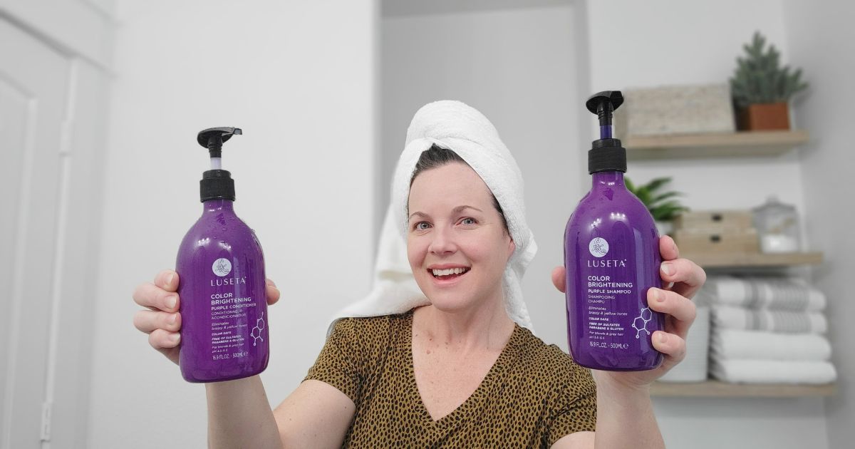 woman holding Luseta Purple Shampoo and Conditioner 
