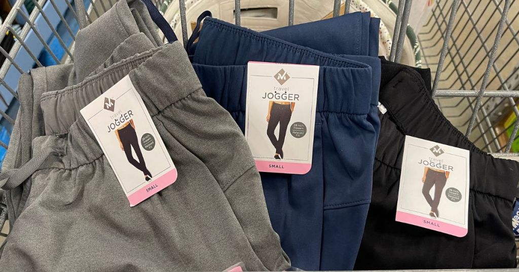 3 pairs of Member's Mark Travel Joggers in the front basket of a shopping cart