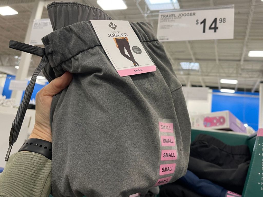 hand holding up a pair of Member's Mark travel joggers under the price sign reading $14.98