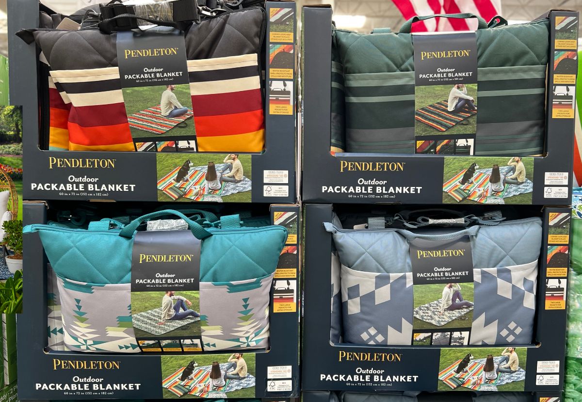Pendleton Packable blankets stacked in a costco store