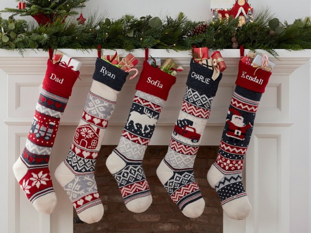 5 different stockings hanging from mantel