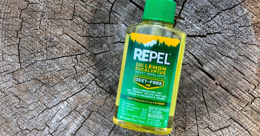 bottle of Repel Lemon Eucalyptus Mosquito Repellent laying on a tree stump