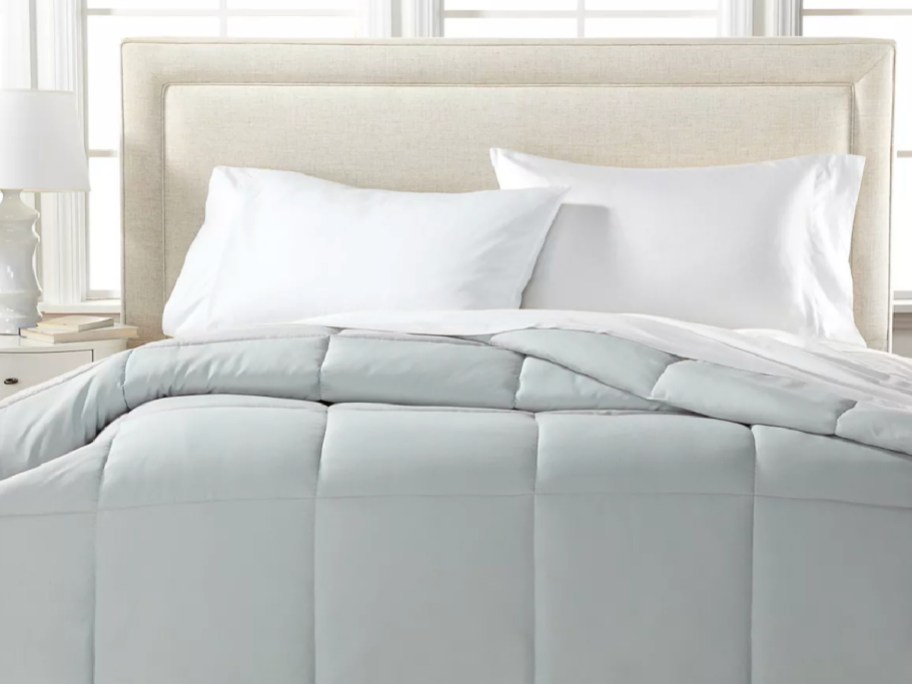 grey comforter on bed