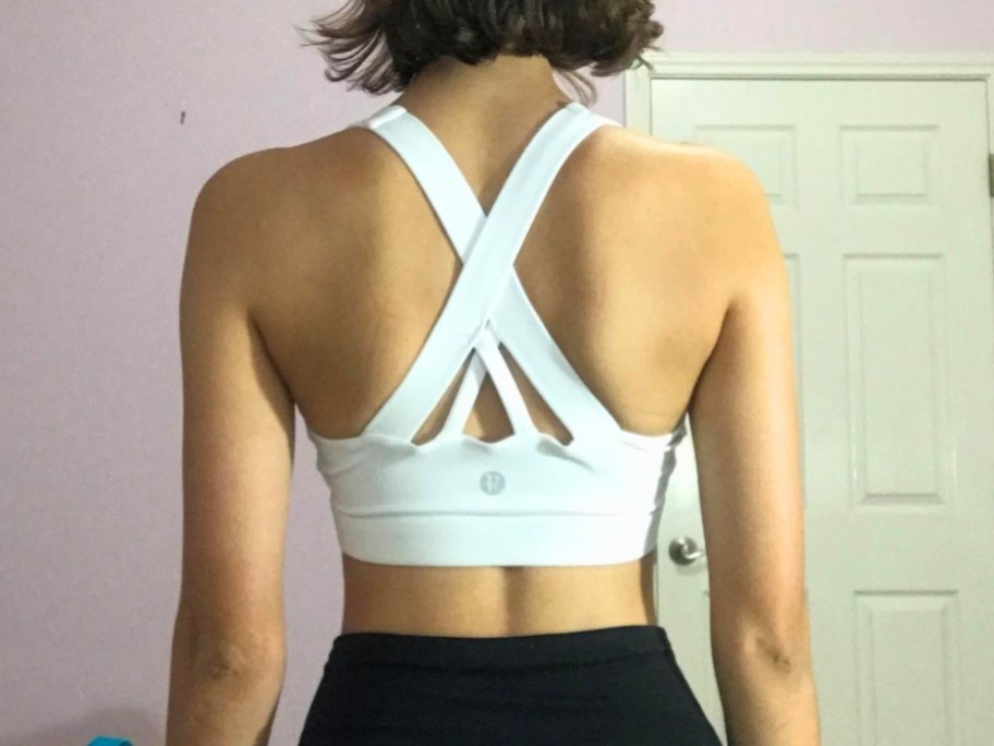 woman wearing white running girl sports bra with back showing
