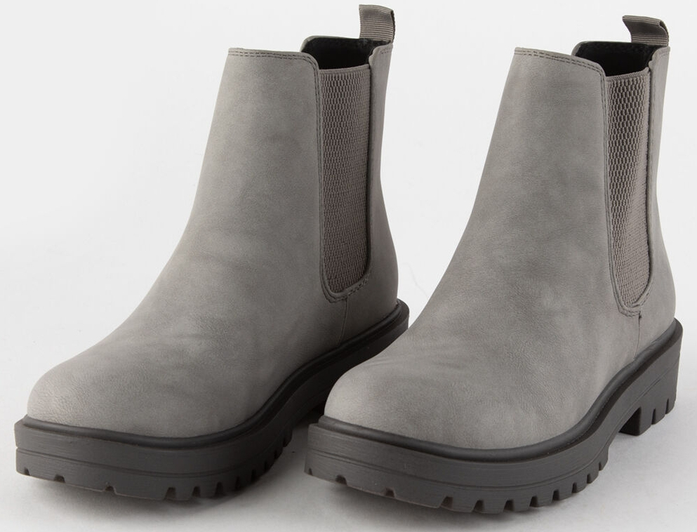 Pair of grey boots with black sole.