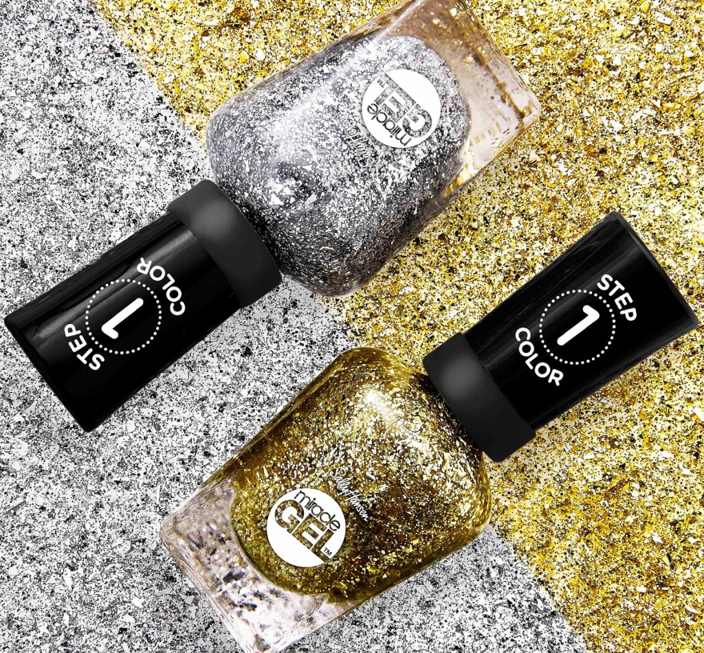 bottles of silver and gold glitter nail polish on a silver and gold glittery background