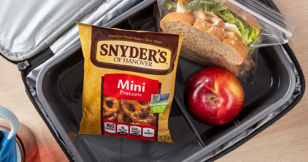 pack of Snyder's Mini Pretzels in a lunchbox with a sandwich and apple