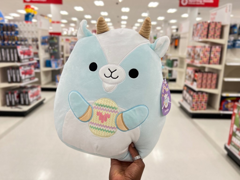 Squishmallows 11 Domingo the Blue Easter Goat Plush in woman's hand at target