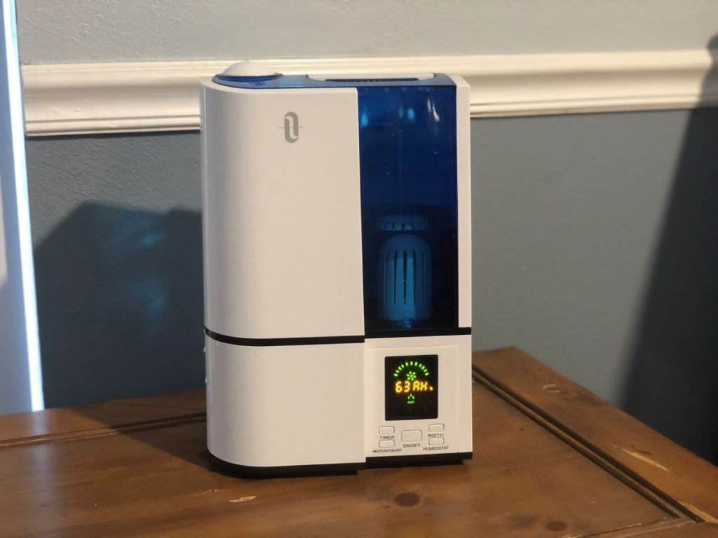 White humidifier with a blue tank on a table