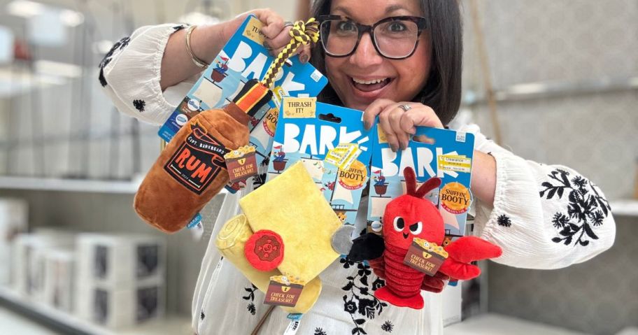 A woman holding dog toys 