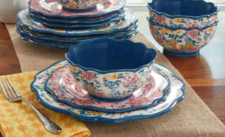 pioneer woman dinnerware place setting on a table.