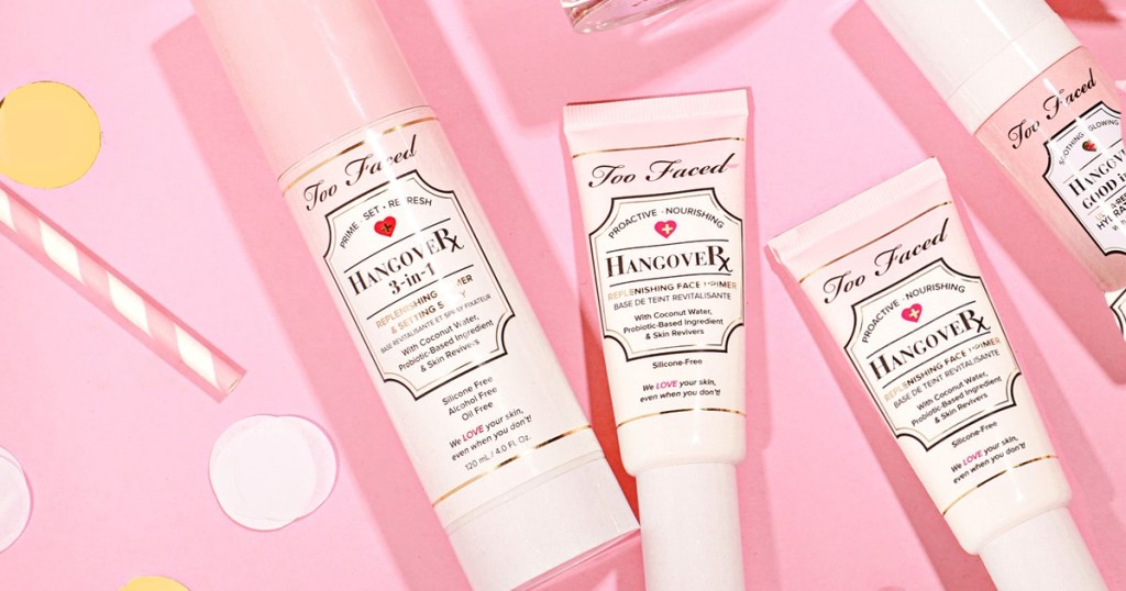 pink bottles of too faced primer and setting spray on pink background