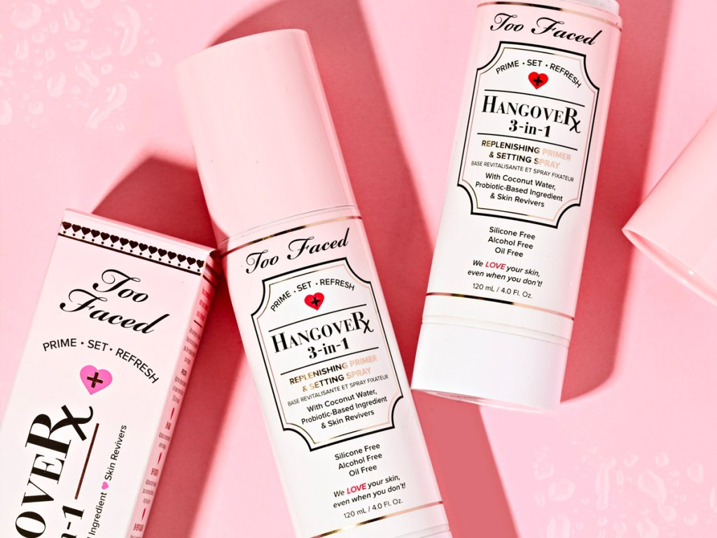 Too Faced Hangover Spray bottles on pink background