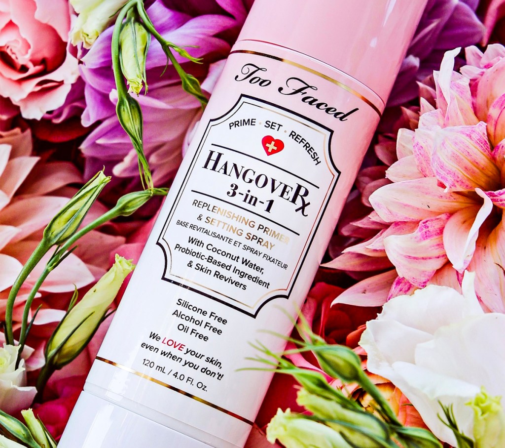 Too Faced Hangover Spray on top of flowers