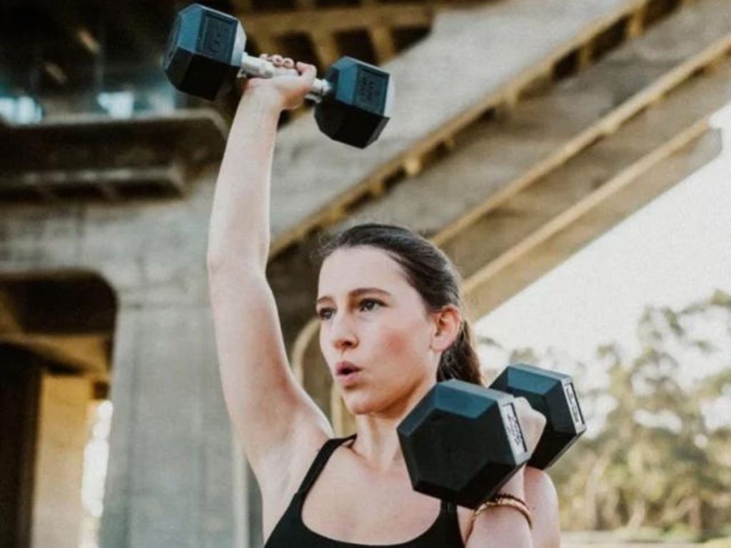 A woman lifting dumbbells