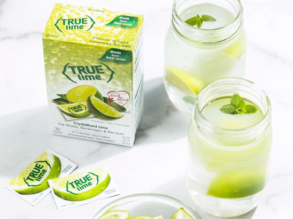 box of true lime next to water glasses with lime