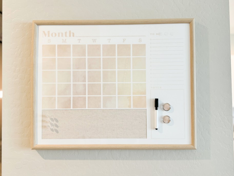 Wall calendar displayed on area of the home with marker and pins