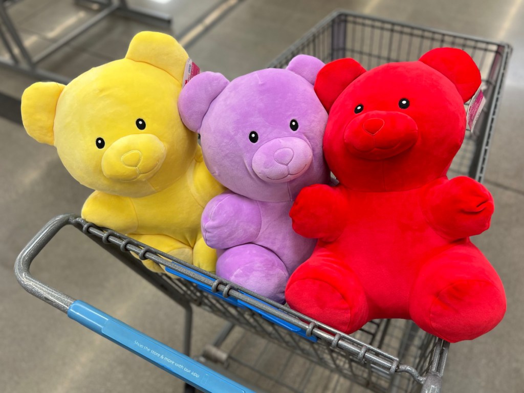 three plush gummy bears in a Walmart shopping cart