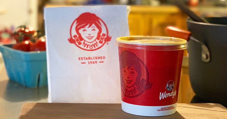 cup of wendy's chili next to wendy's bag