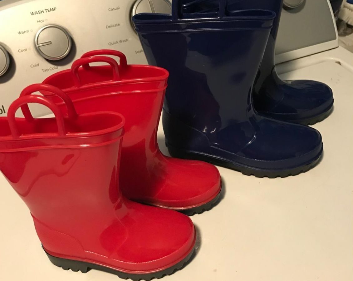 2 pairs of Zoogs rain boots on a washing machine