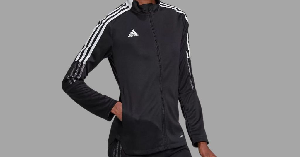 person wearing adidas black and white track suit