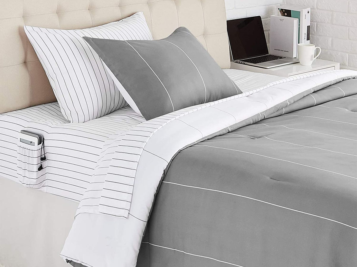 white sheet set with gray comforter on bed