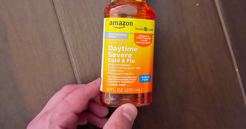 man holding amazon daytime flu medicine