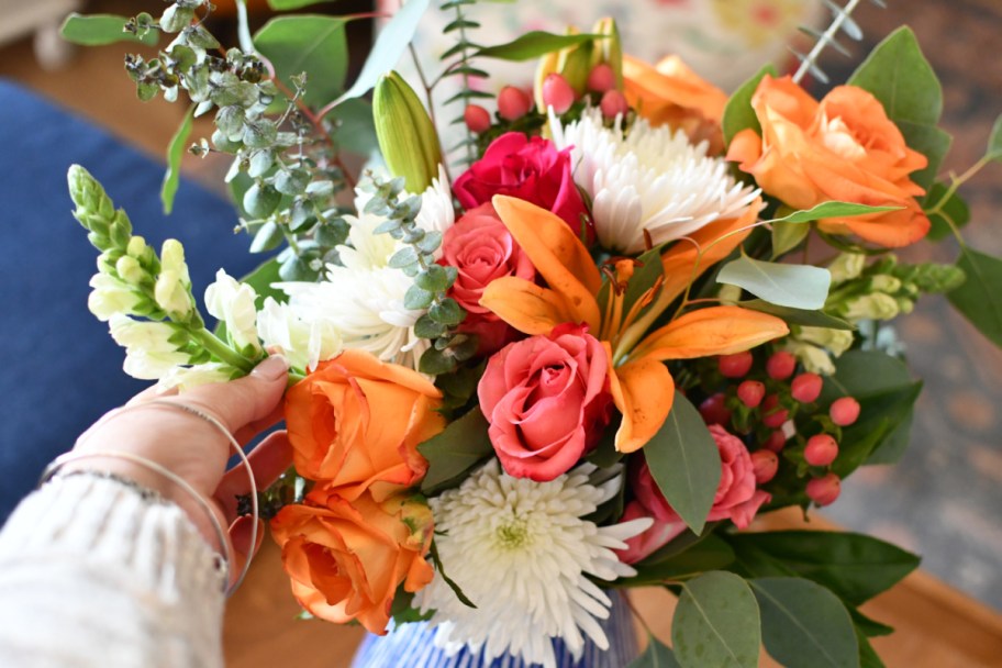 arranging flowers in a vase