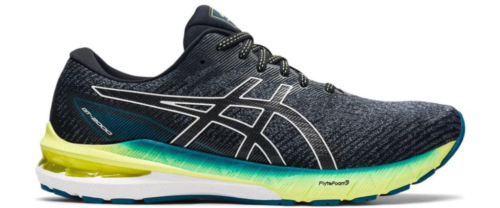 black white and green Asics shoe