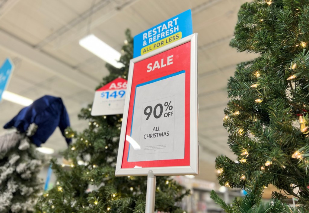 90 percent off at home christmas clearance sign in front of trees