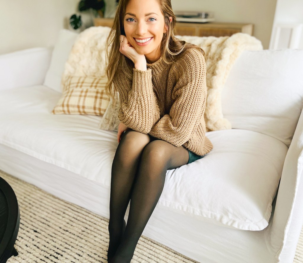 woman sitting on white couch wearing black fleece lined tights