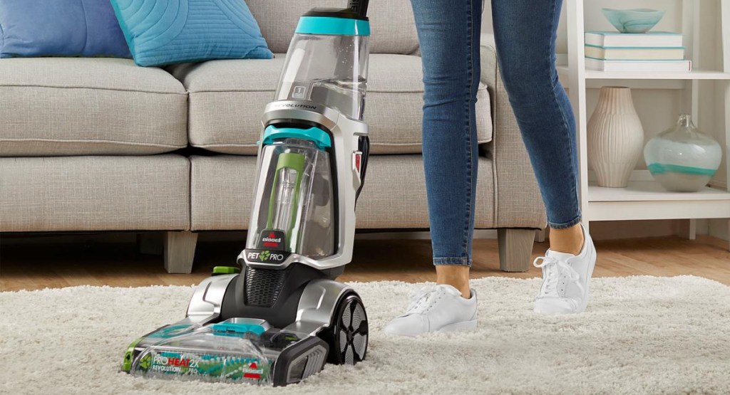 brisell carpet cleaner with woman moving it