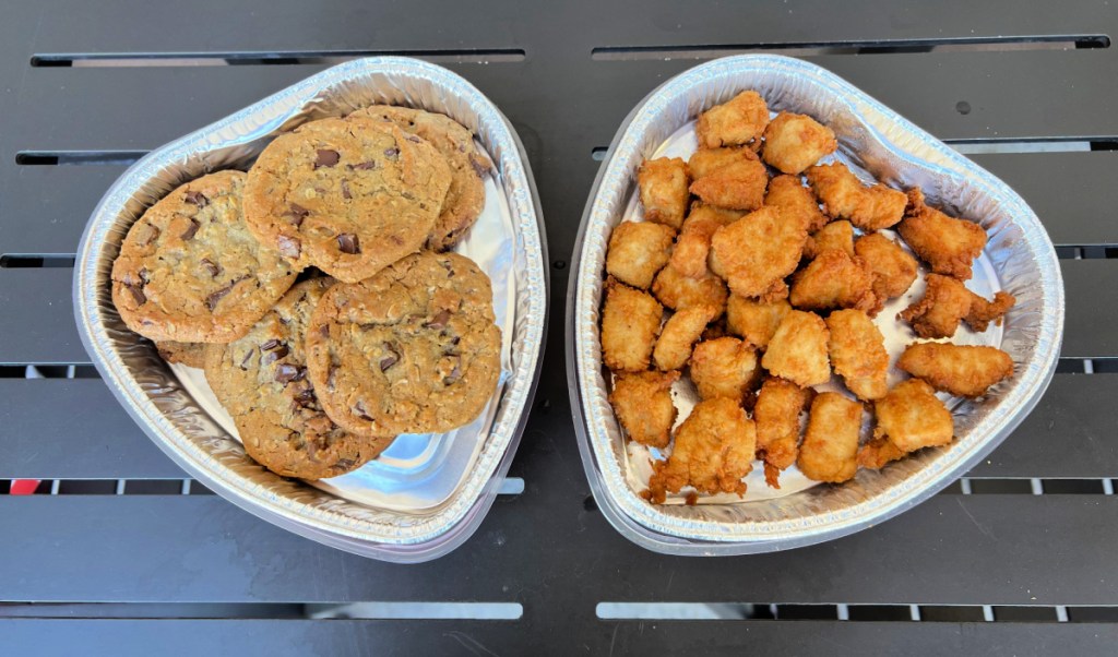 two side by side heart shaped trays of cookies and chick fil a chicken nuggets