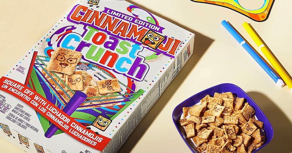 cinnamon toast crunch box laying next to a bowl of cereal