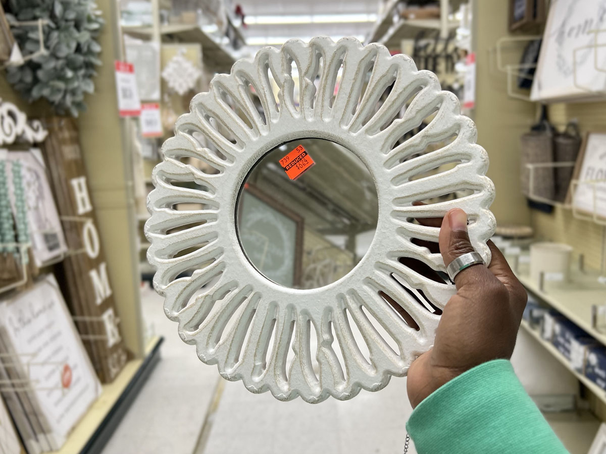 hand holding white circle mirror