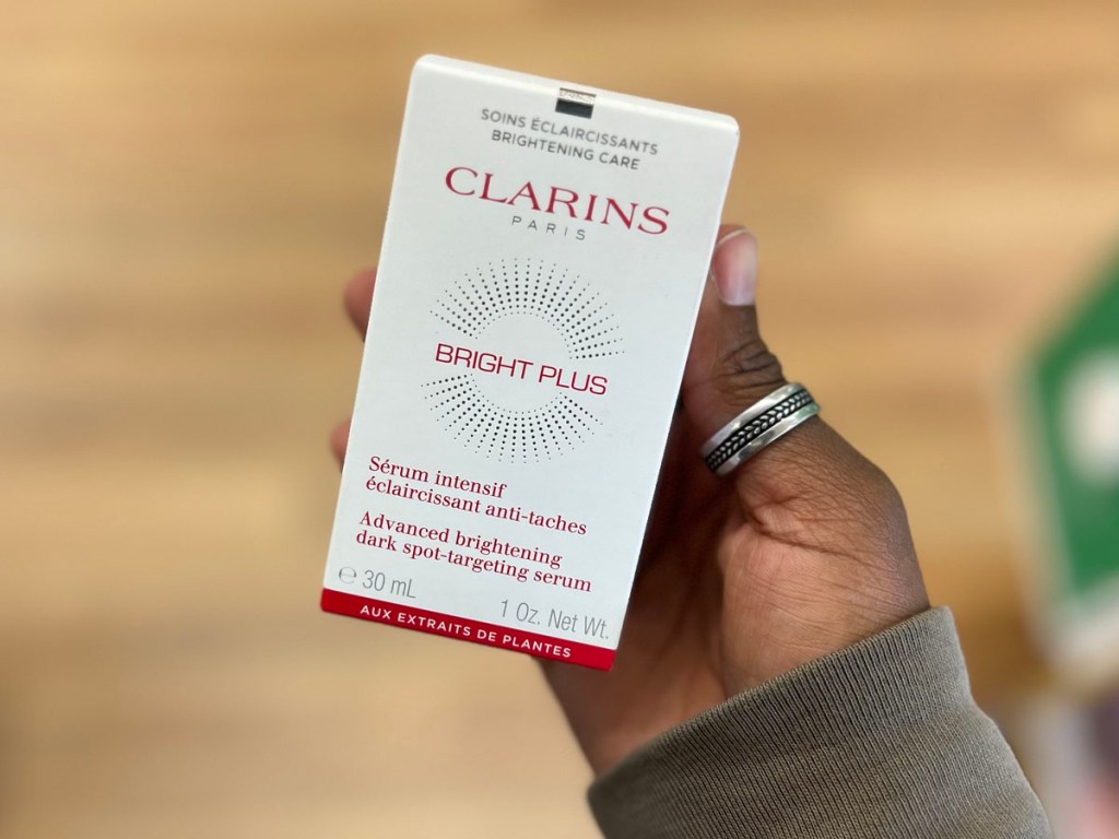 Clarins bright plus serum in womans hand