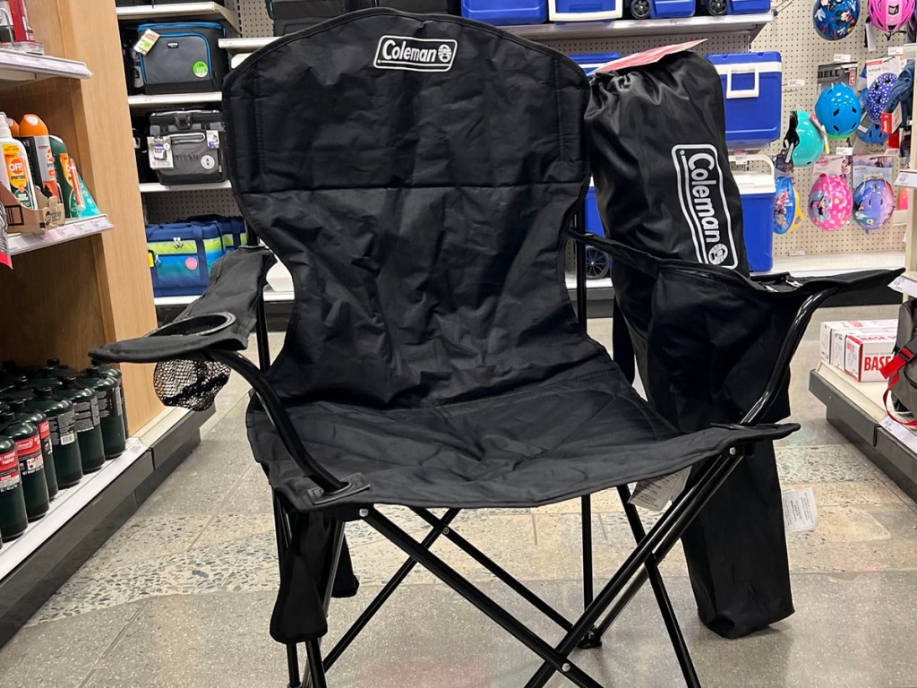 black coleman camping chair in aisle with bag