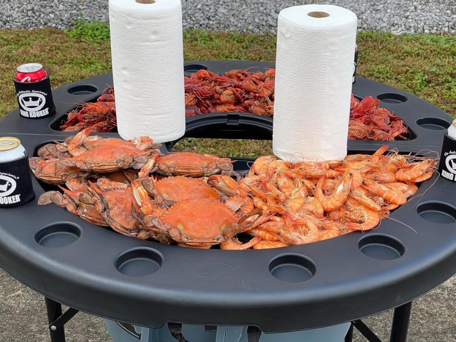 crawfish table full of seafood, drinks, and paper towels