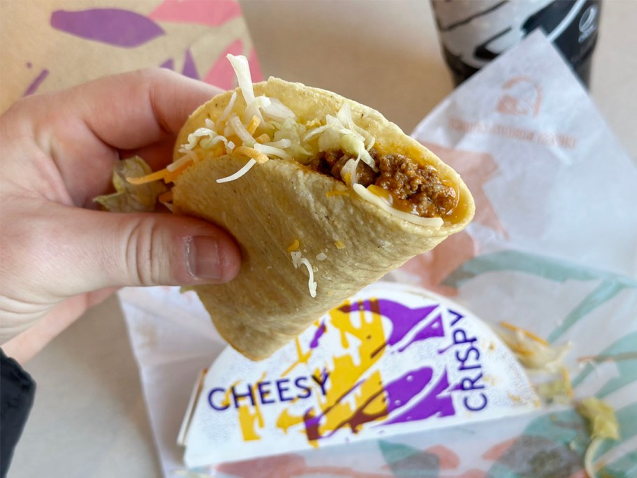 hand holding crispy taco at taco bell