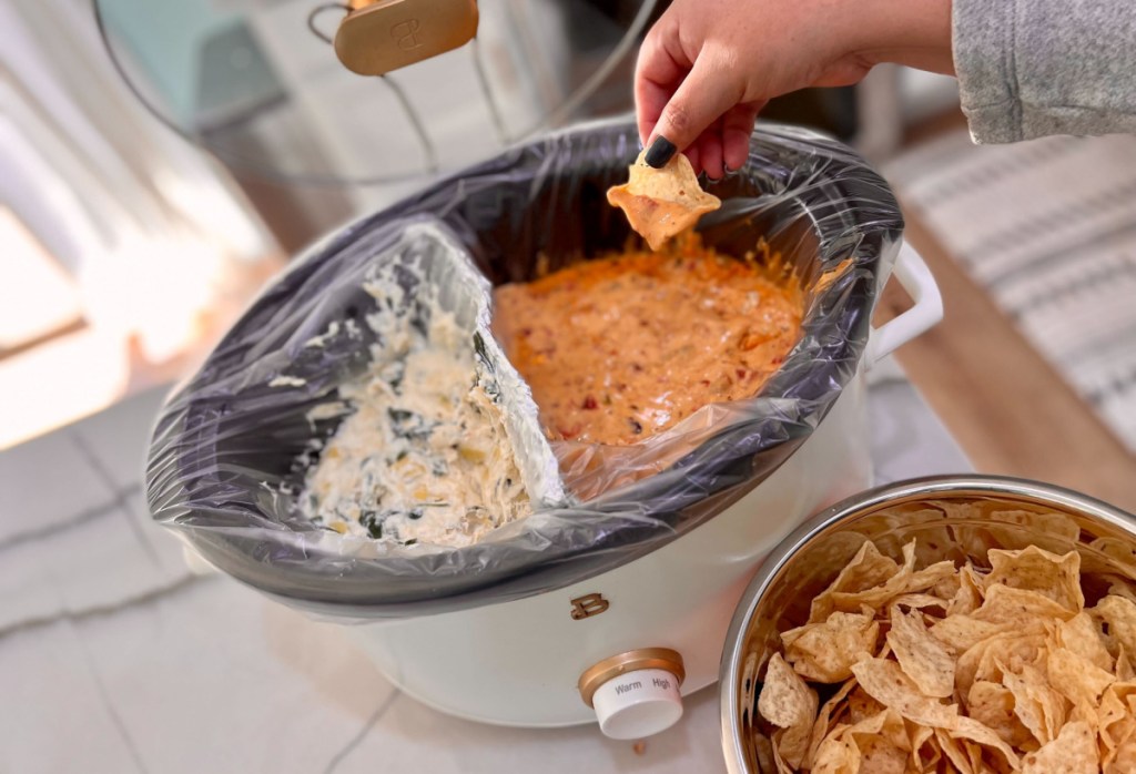 Crockpot with aluminum foil divider to make two dips at a time.