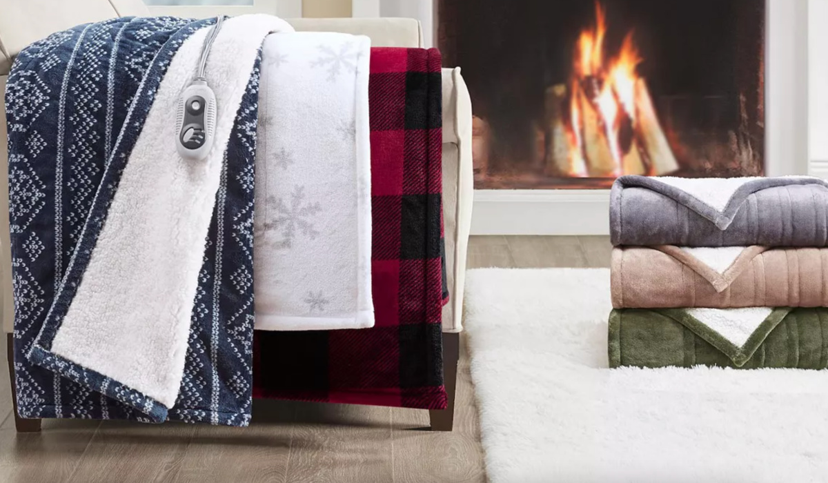 electric blankets draped over couch with a fireplace in the background