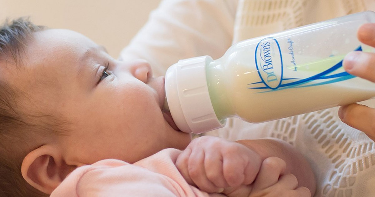 woman feeding baby with dr browns baby bottle