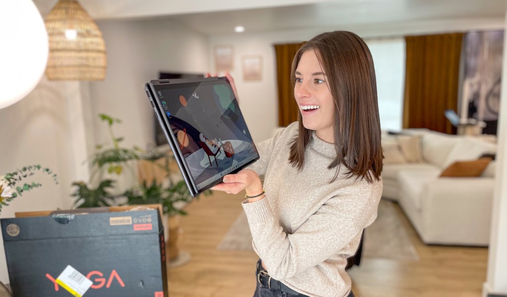 Woman holding up foldable tablet in living room