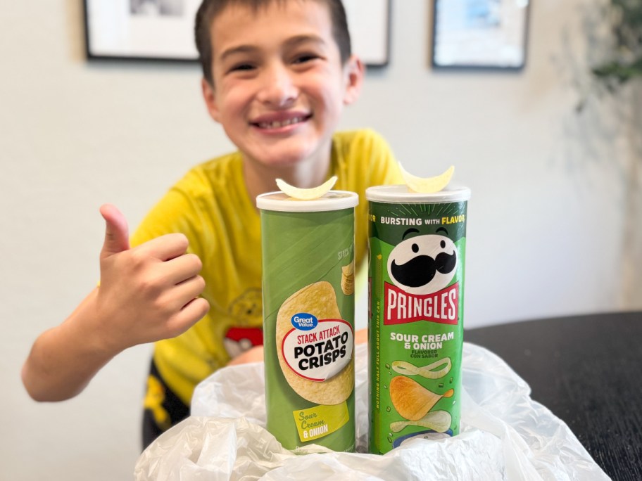 boy giving thumbs up with great value chips and pringles