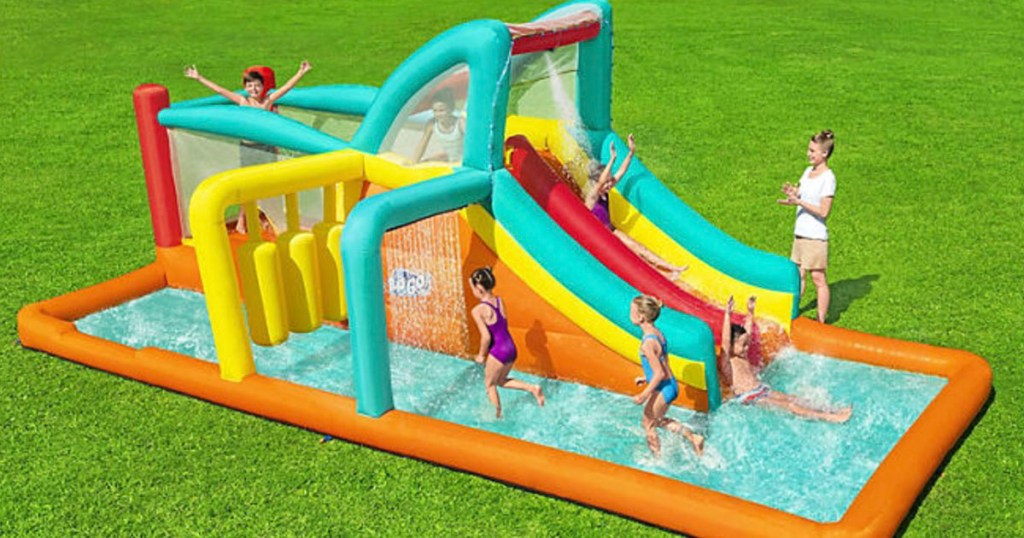kids playing in large waterpark with slide
