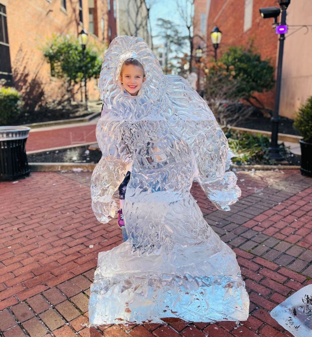 girls face in giant big foot ice sculpture 