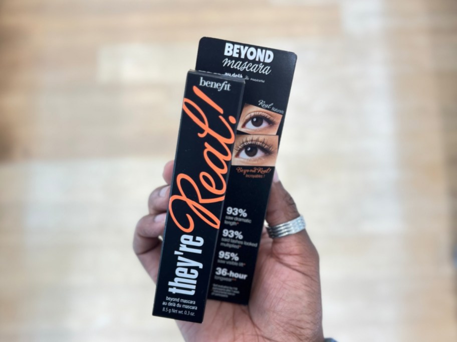 image of Benefit Cosmetics They're Real! Lengthening Mascara  in woman's hand
