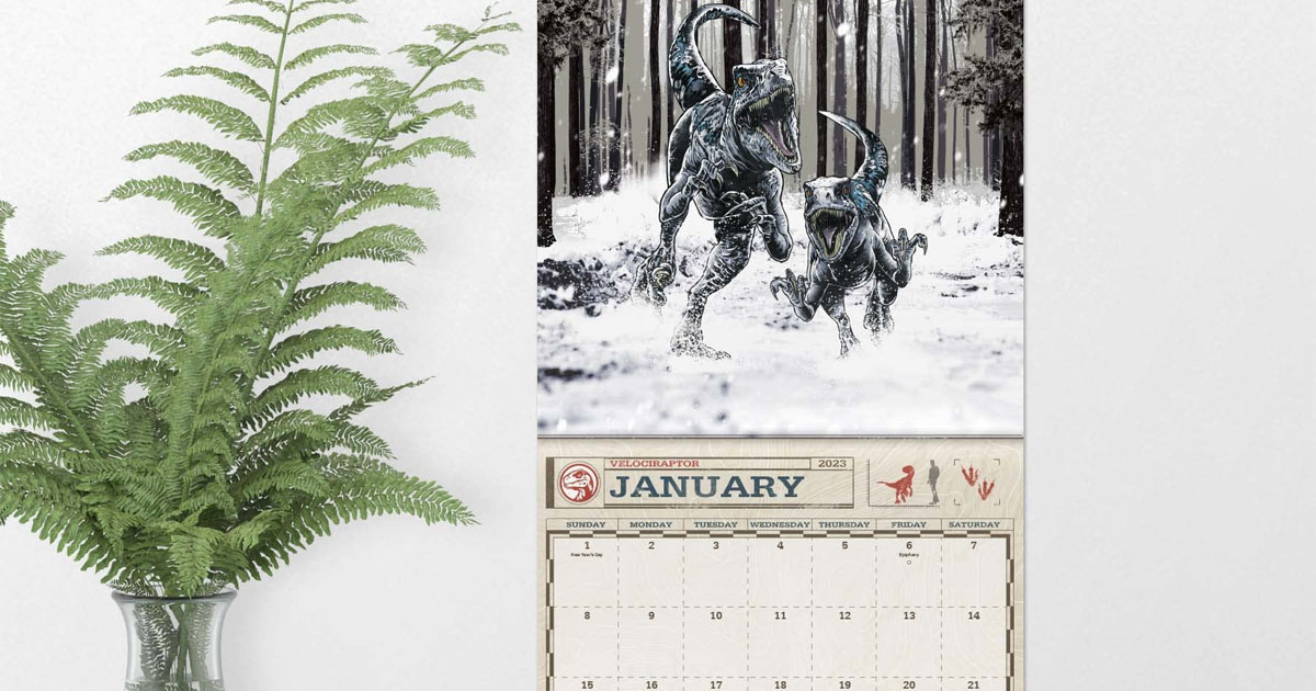 jurassic park calendar hanging on wall with plant