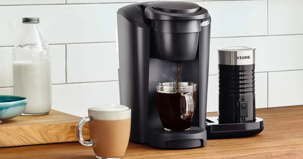 black keurig coffee maker brewing coffee into mug