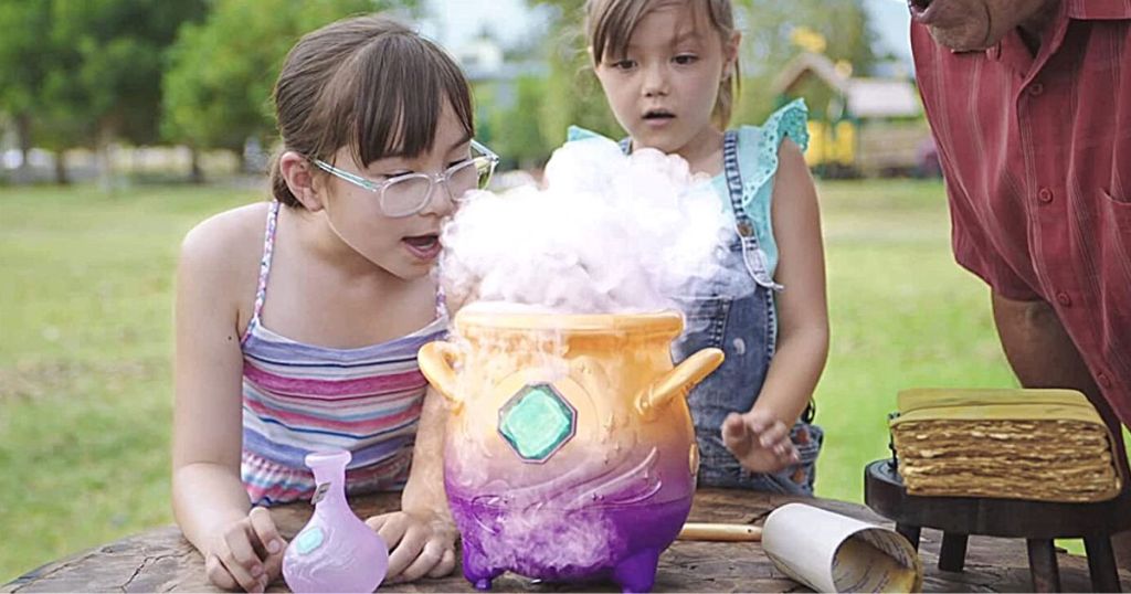 2 girls and adult watching mist come from Magic Mixies Cauldron